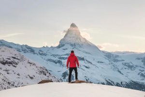 Man looking up at Snowy mountain